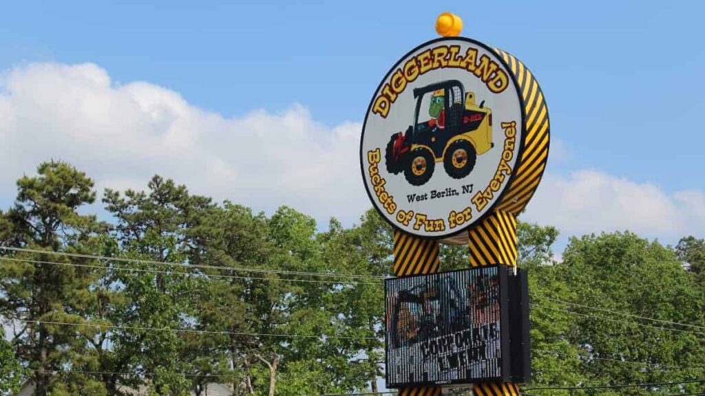 Looking up a large signs with "Diggerland" and a construction vehicle