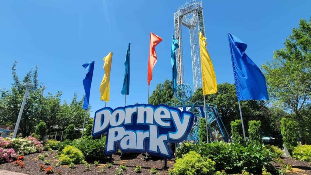 A large "Dorney Park" sign with blue, yellow, and red flags behind it