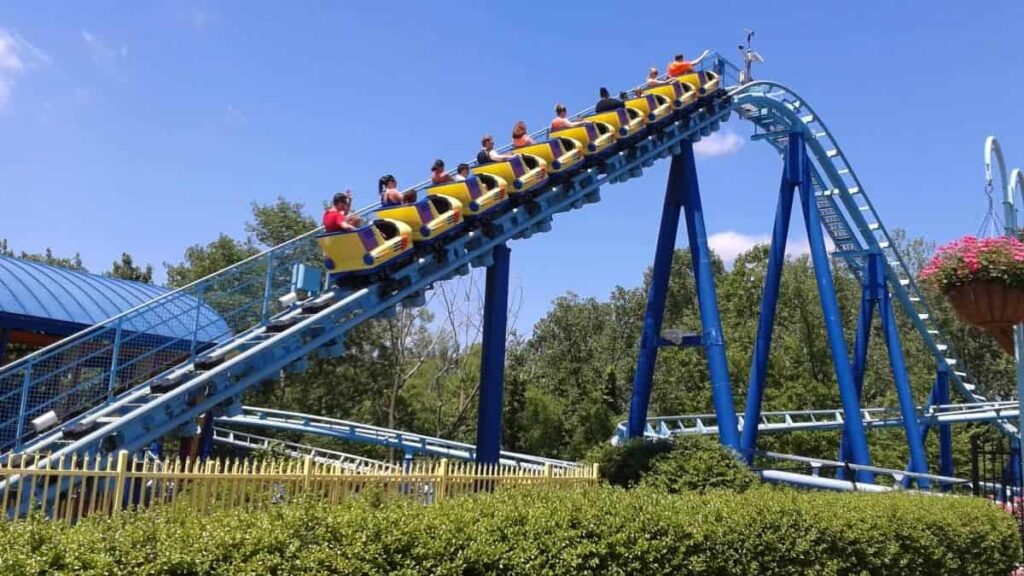 A roller coaster climbs a small hill at Sesame Place in Langhorne