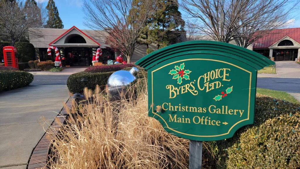 a green sign states "Byers Choice Christmas Gallery" with the entrance in the background