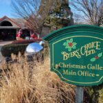 a green sign states "Byers Choice Christmas Gallery" with the entrance in the background