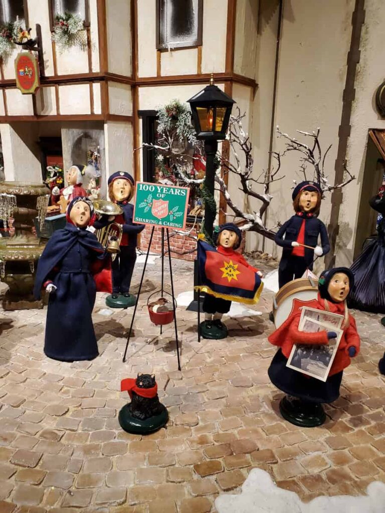 Various Byer's Choice caroler dolls set up in winter scene