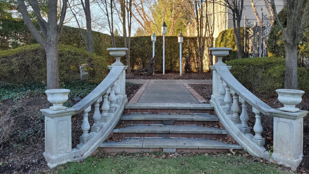 decorative stone steps lead to formal gardens in the winter time