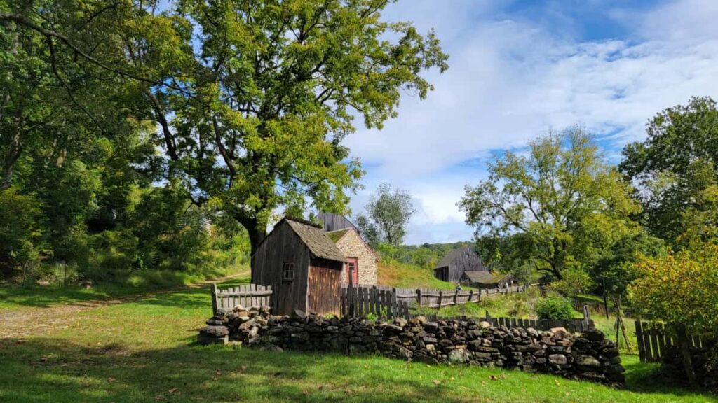 view of an old wooden structure and stone wall inside Ridley Creek State Park