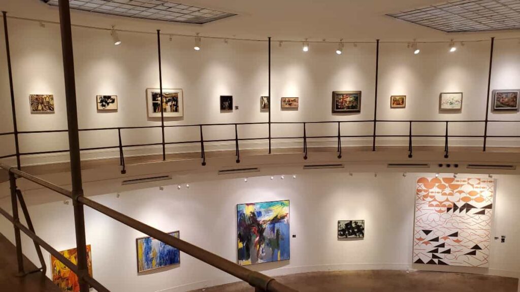 Standing on the second level of an open gallery at Woodmere Art Museum