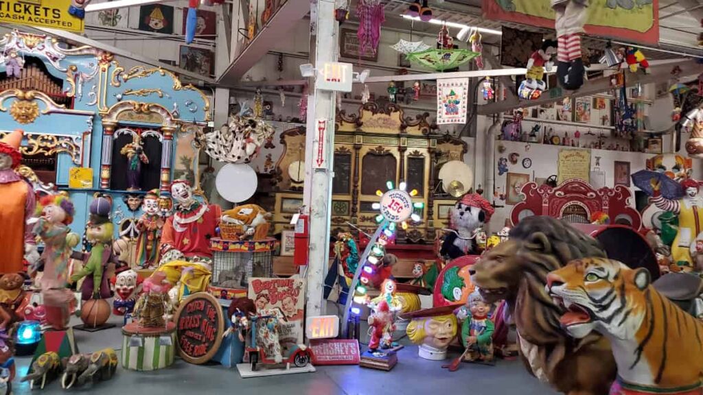 Looking at several pieces of large memorabilia inside the American Treasure Tour Museum