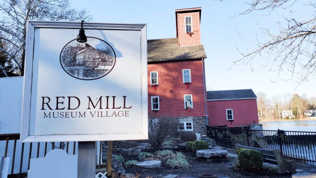 A sign reads 'Red Mill Museum" with a red building in the background