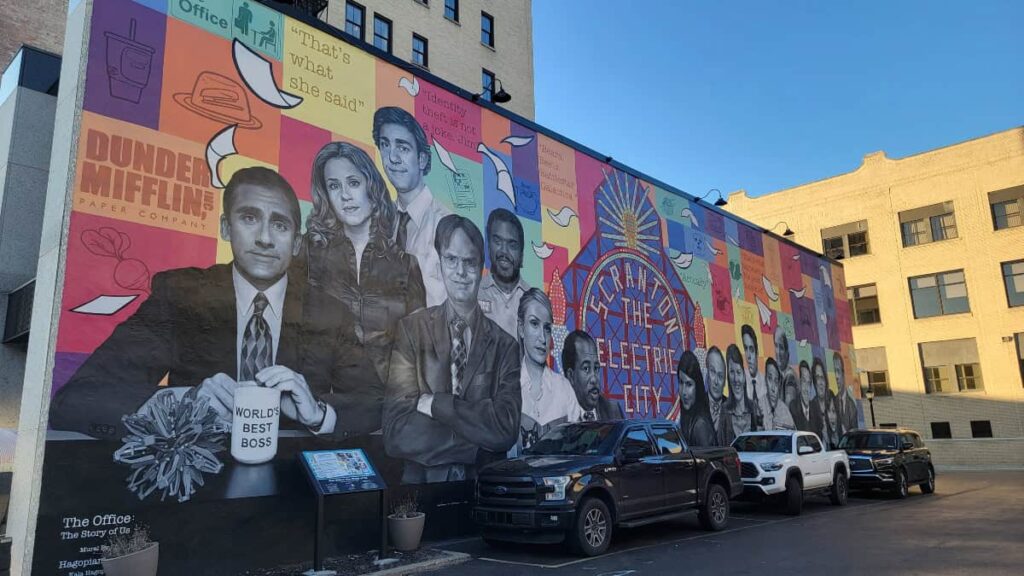 a mural of The Office characters is on a wall in Scranton